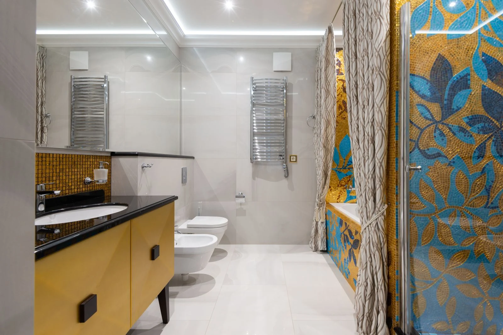Elegant bathroom featuring a colorful floral mosaic, stylish fixtures, and modern design elements